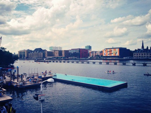 703327_berlins-arena-badeschiff-pool-floats-inside-of-the-river-spree-where-visitors-can-swim-in-clean-water-and-enjoy-views-of-the-surrounding-city-food-drinks-music-and-lounge-chairs-are-also-available-from-open-to-close